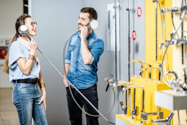 Couple choosing shower faucet in the shop