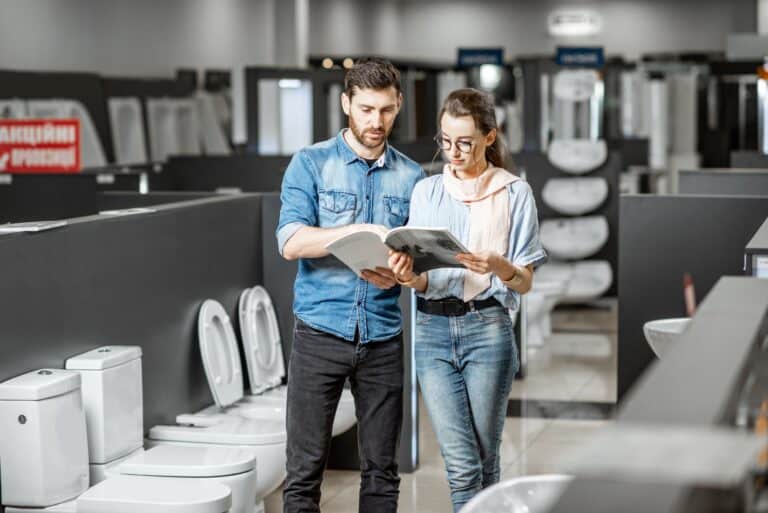 Couple choosing toilet ceramics in the shop